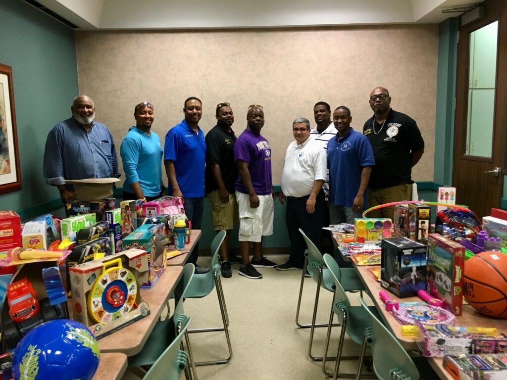 Xmas in July 2018 Toy Donation to Salvation Army Shelter - District Photo